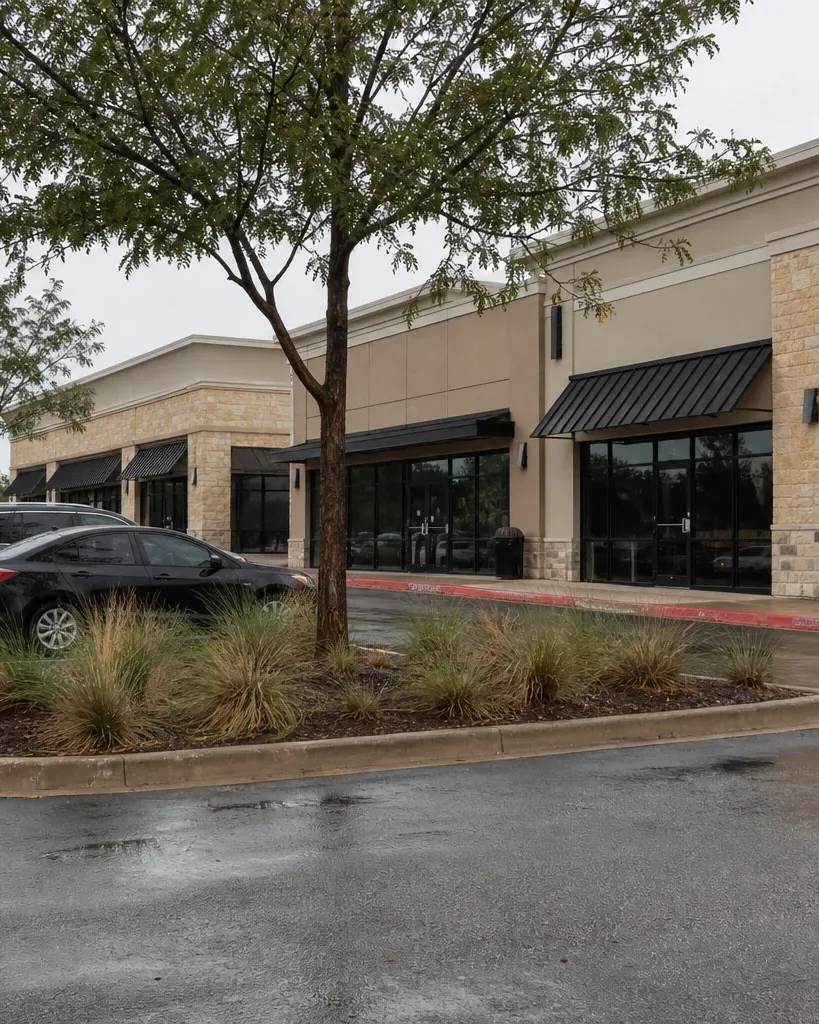 A stabilized Austin retail anchored center is seen from the front of its surface parking lot