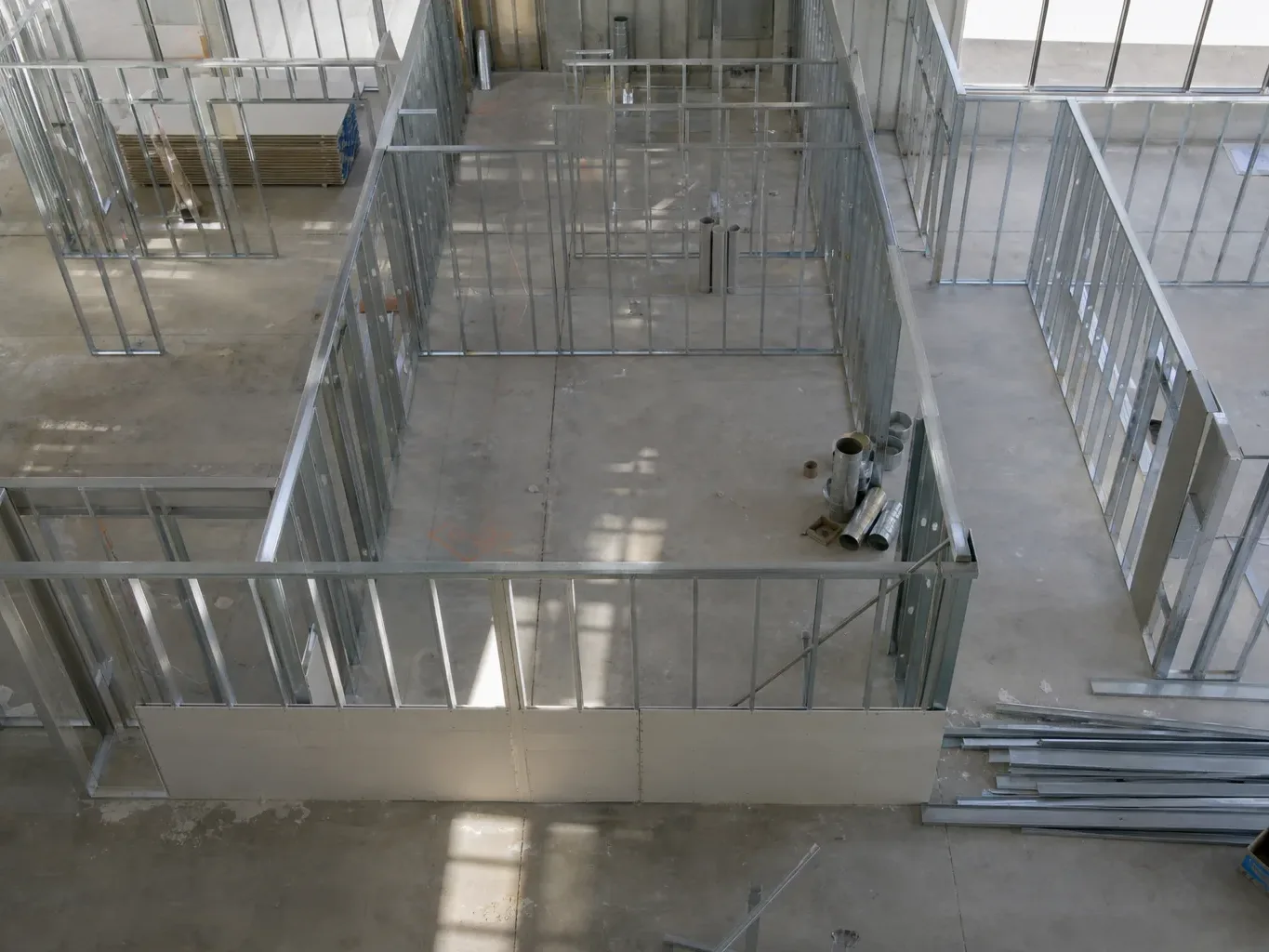 A tenant improvement build-out fills a vacant Austin suite with steel studs and partial drywall